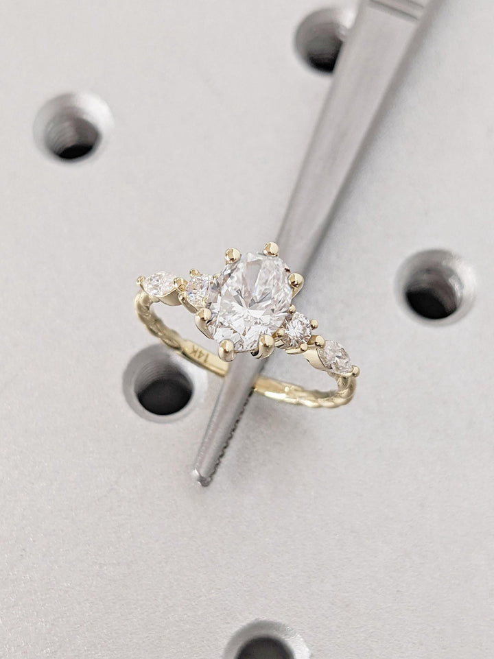 Detailed close-up of oval cluster diamond engagement ring