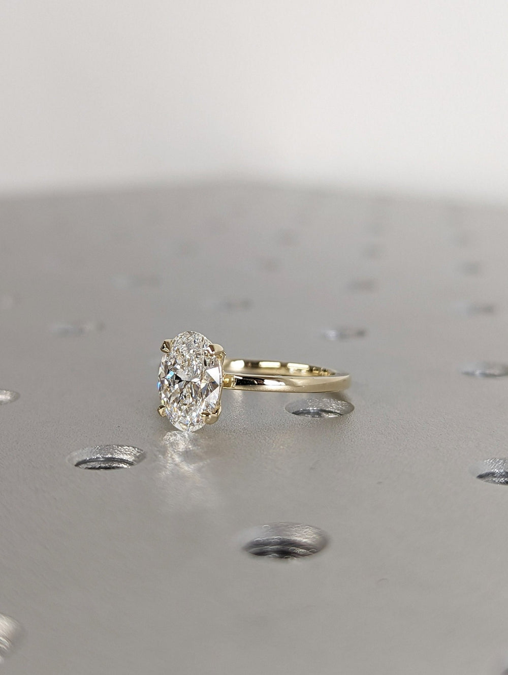 Oval solitaire lab grown diamond ring fitted on finger