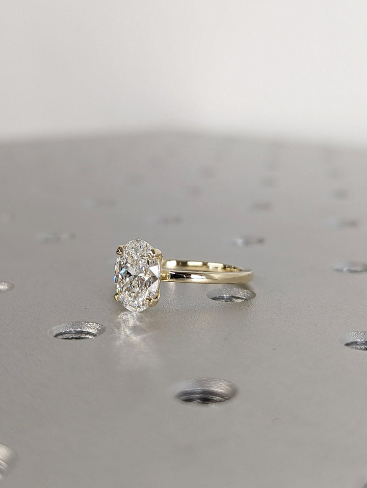Oval solitaire lab grown diamond ring fitted on finger