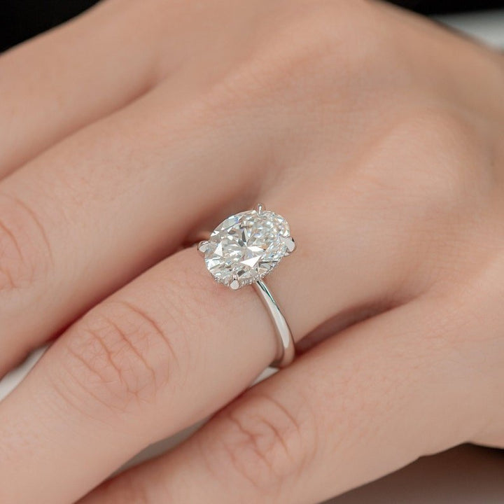 Fine craftsmanship detail on oval hidden halo engagement ring