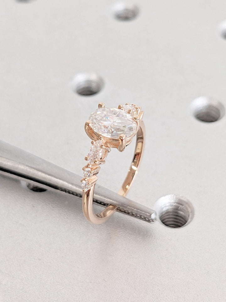 Oval cluster diamond ring displayed on jewelry stand