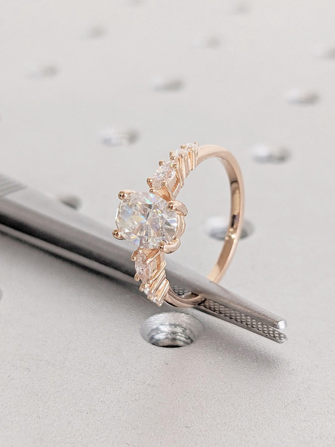 Angled view of oval cut diamond in cluster setting