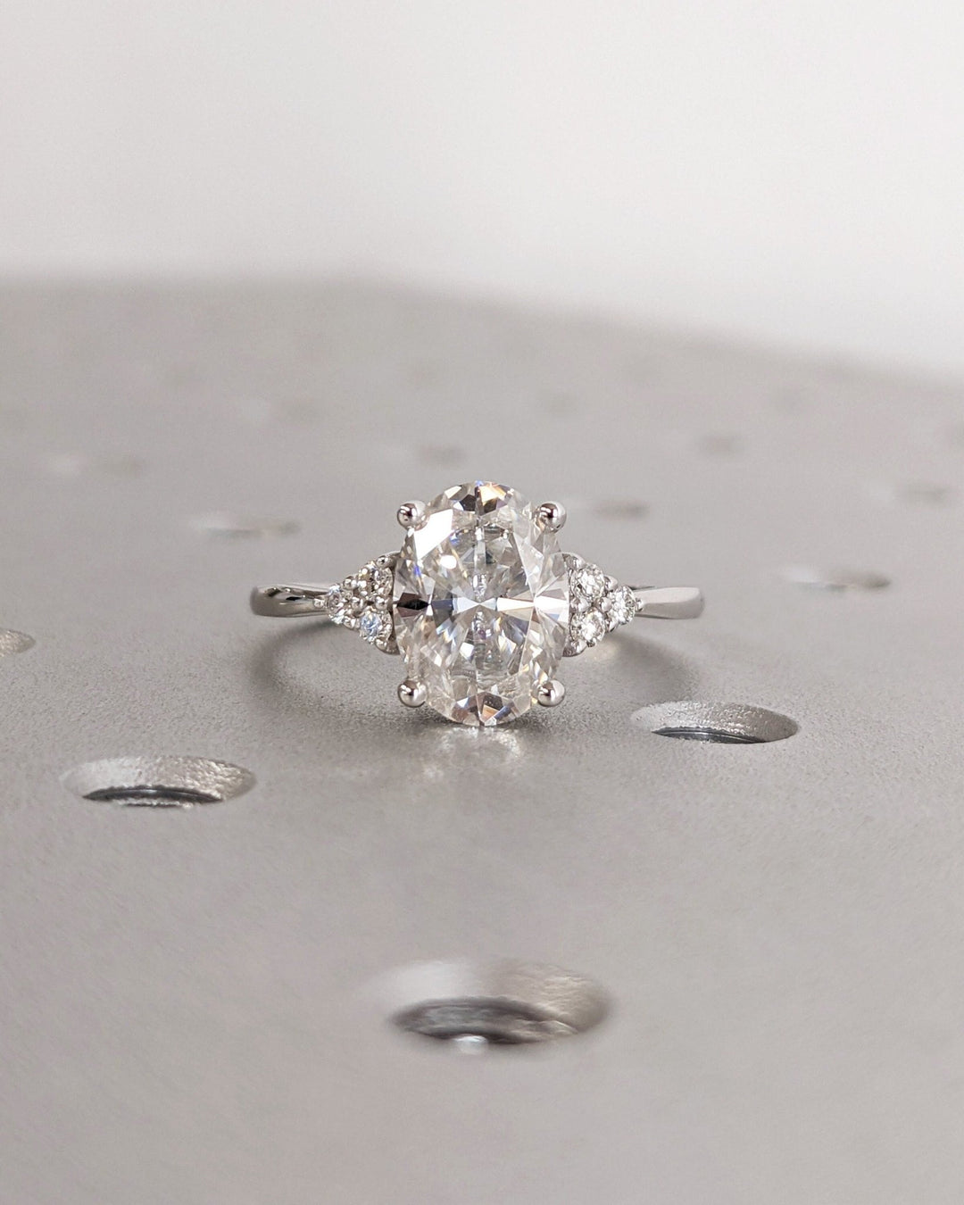 Oval cluster engagement ring close-up highlighting diamond sparkle