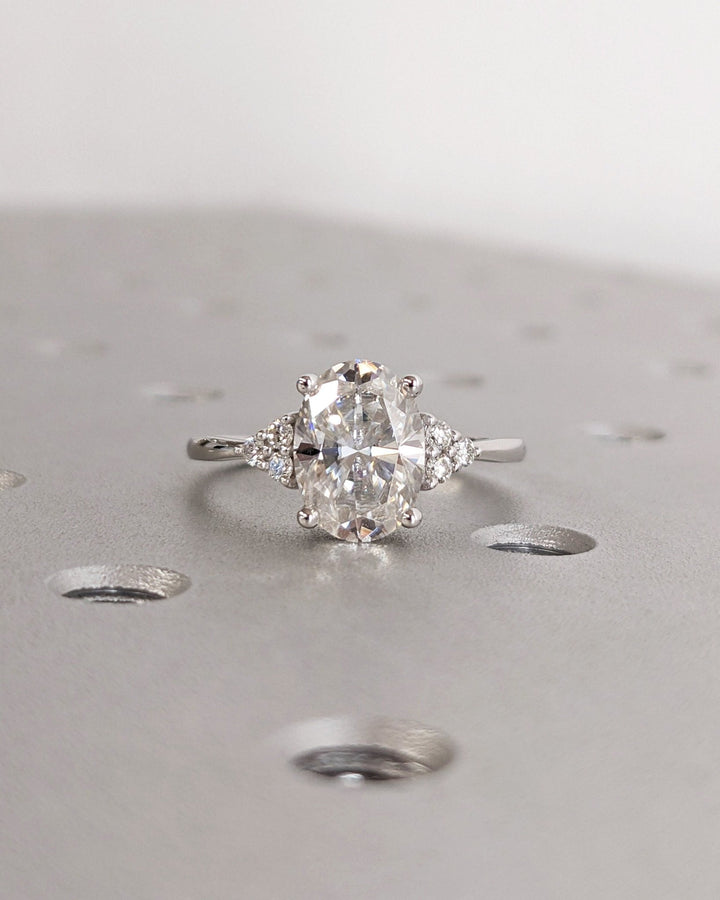 Oval cluster engagement ring close-up highlighting diamond sparkle