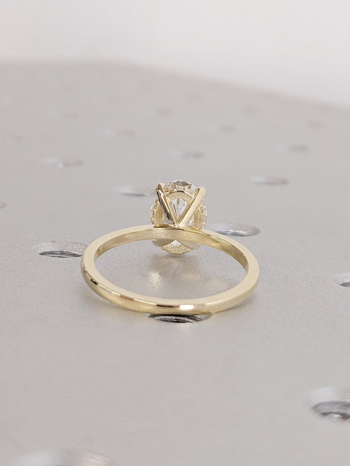 Oval cut diamond ring worn on hand