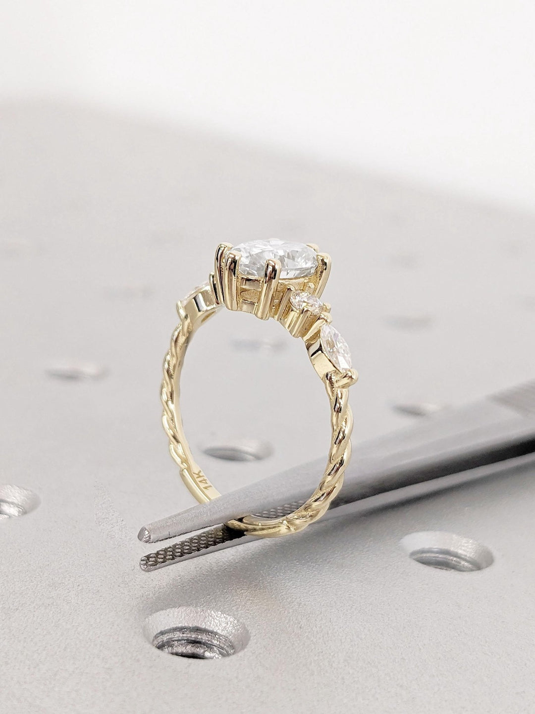 Side angle of oval cluster diamond engagement ring