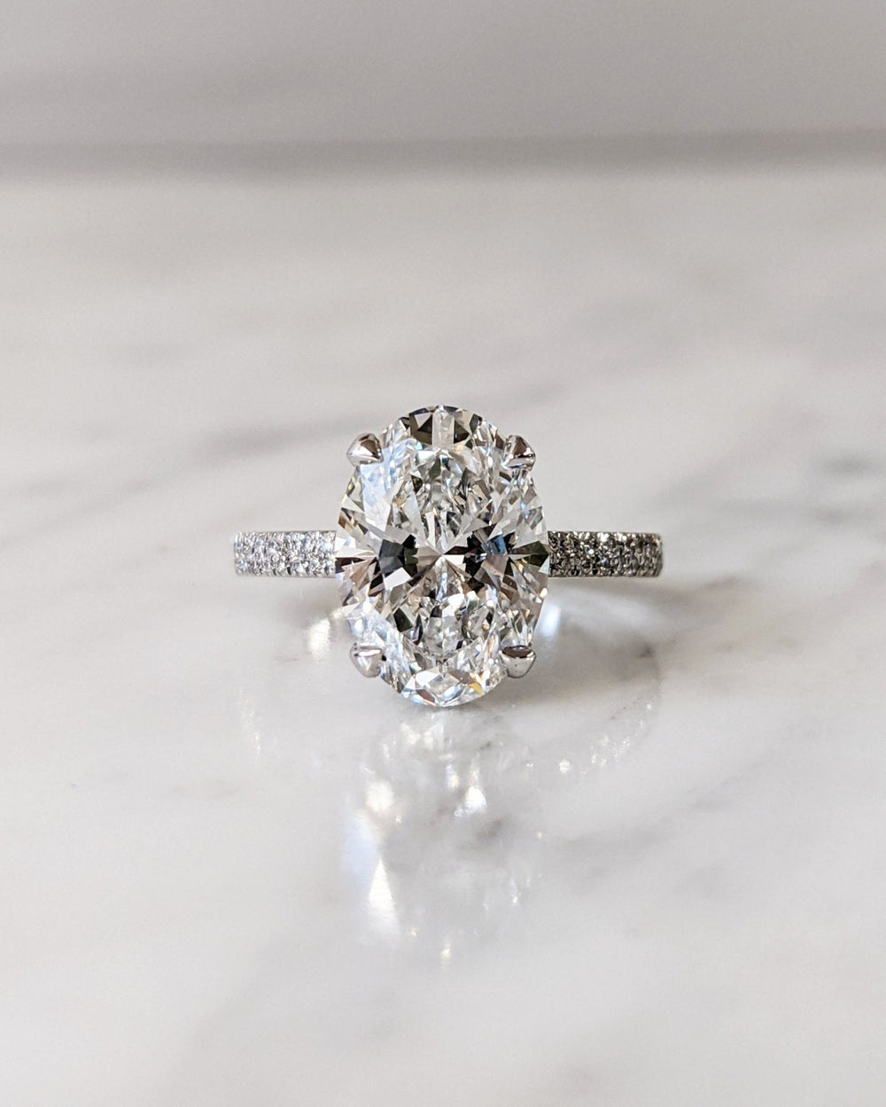 Oval hidden halo lab grown diamond ring fitted on finger