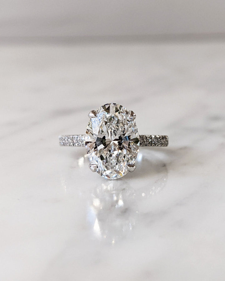 Oval hidden halo lab grown diamond ring fitted on finger