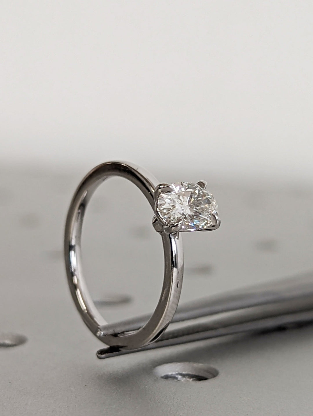 Close-up of oval cut center diamond in solitaire engagement ring