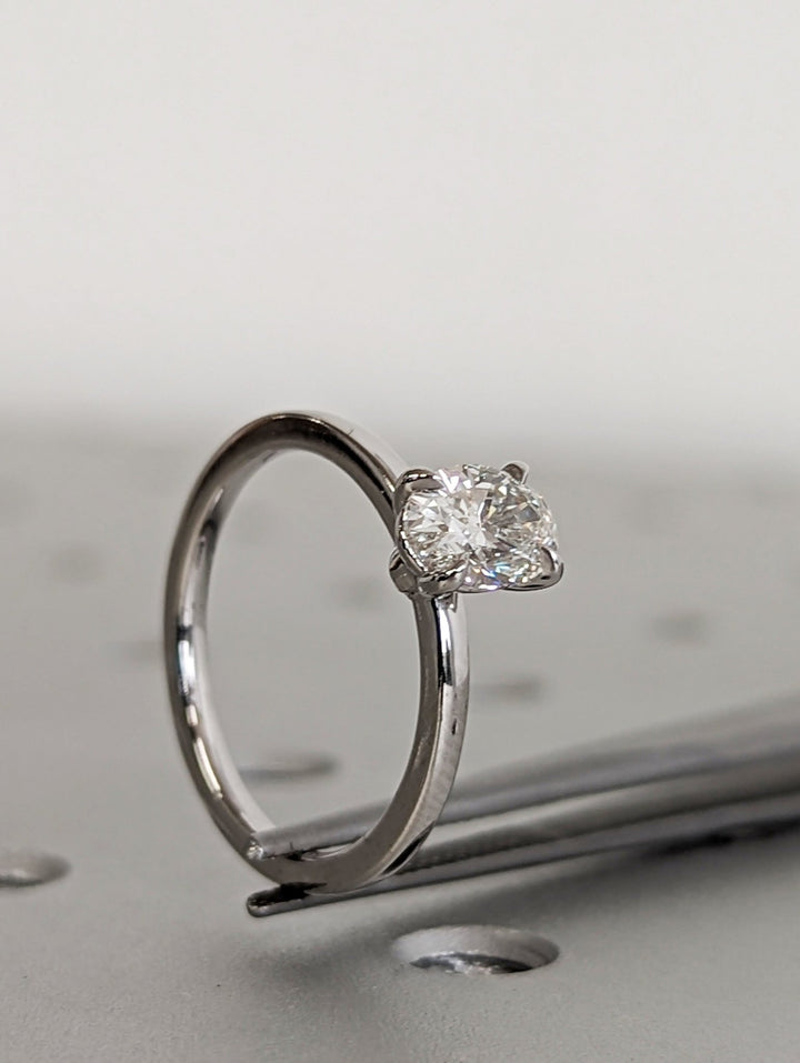 Close-up of oval cut center diamond in solitaire engagement ring