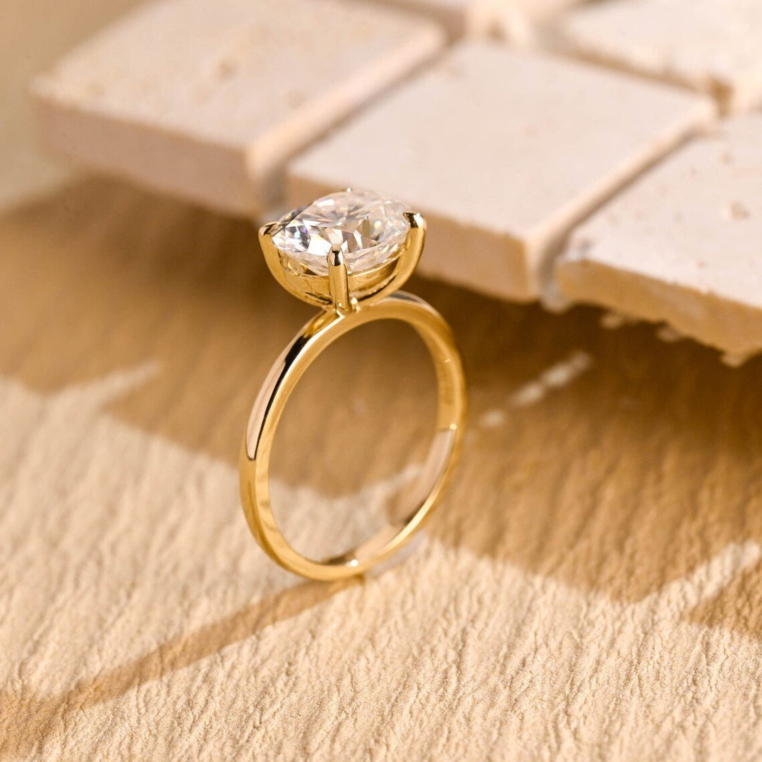 Close-up of oval cut center diamond in east west engagement ring