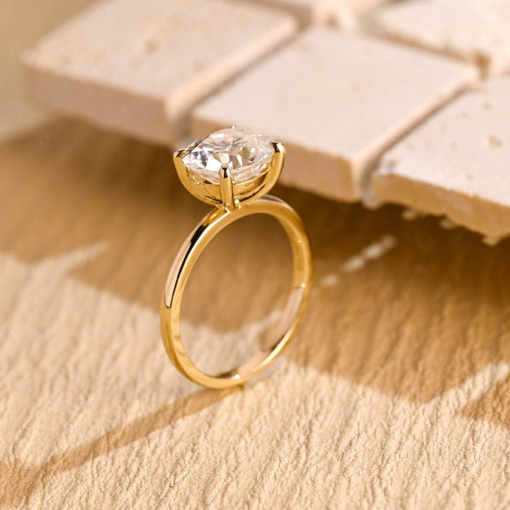 Close-up of oval cut center diamond in east west engagement ring