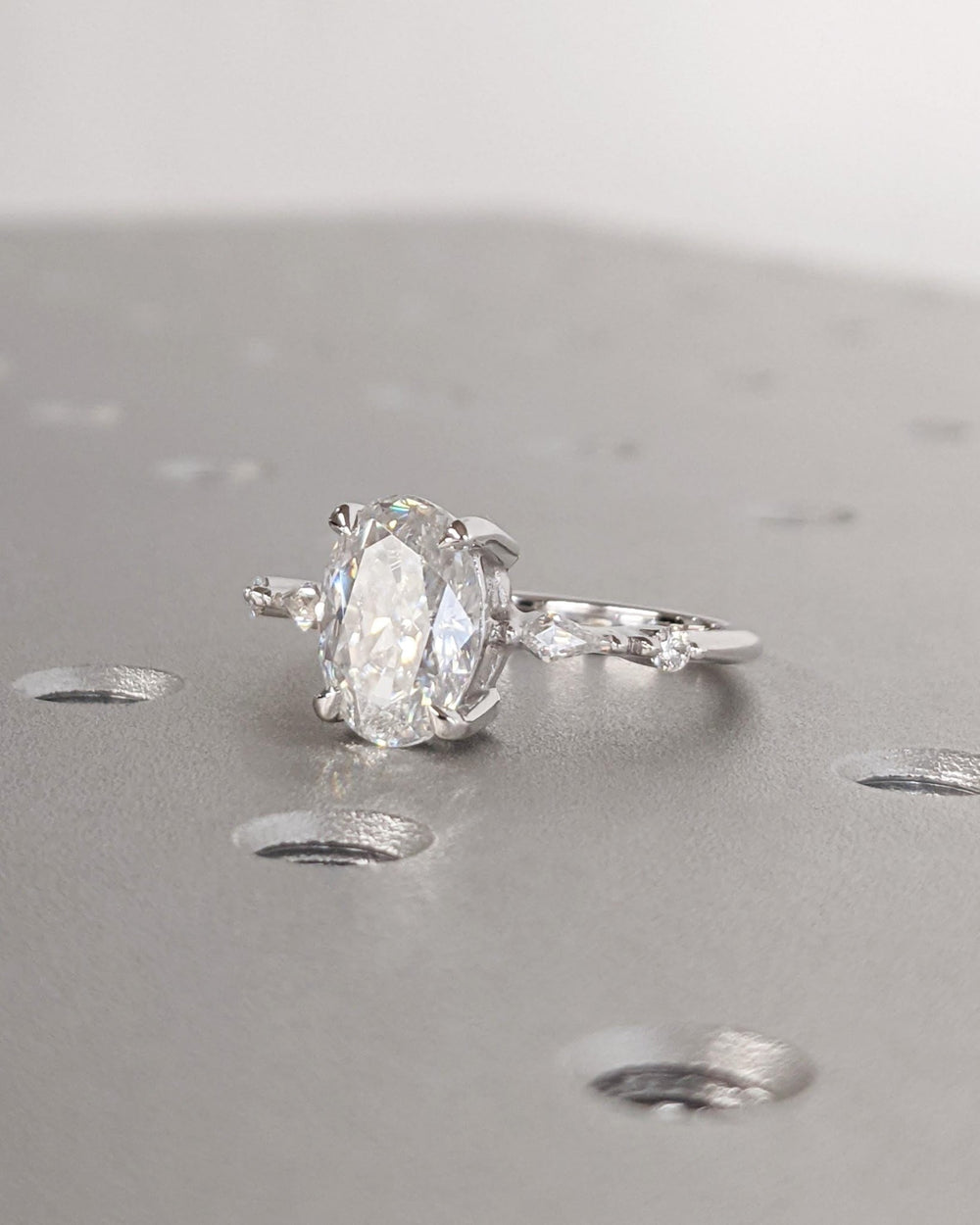 Certified oval cut diamond featured in cluster engagement ring