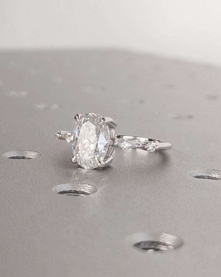 Certified oval cut diamond featured in cluster engagement ring