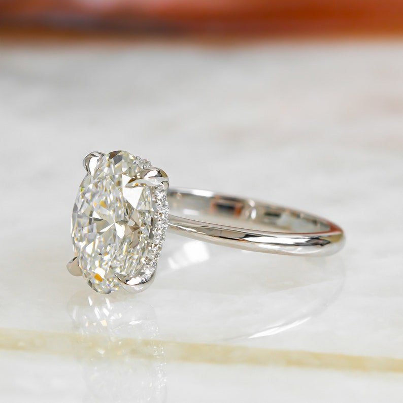 Classic oval hidden halo engagement ring crafted for everyday wear