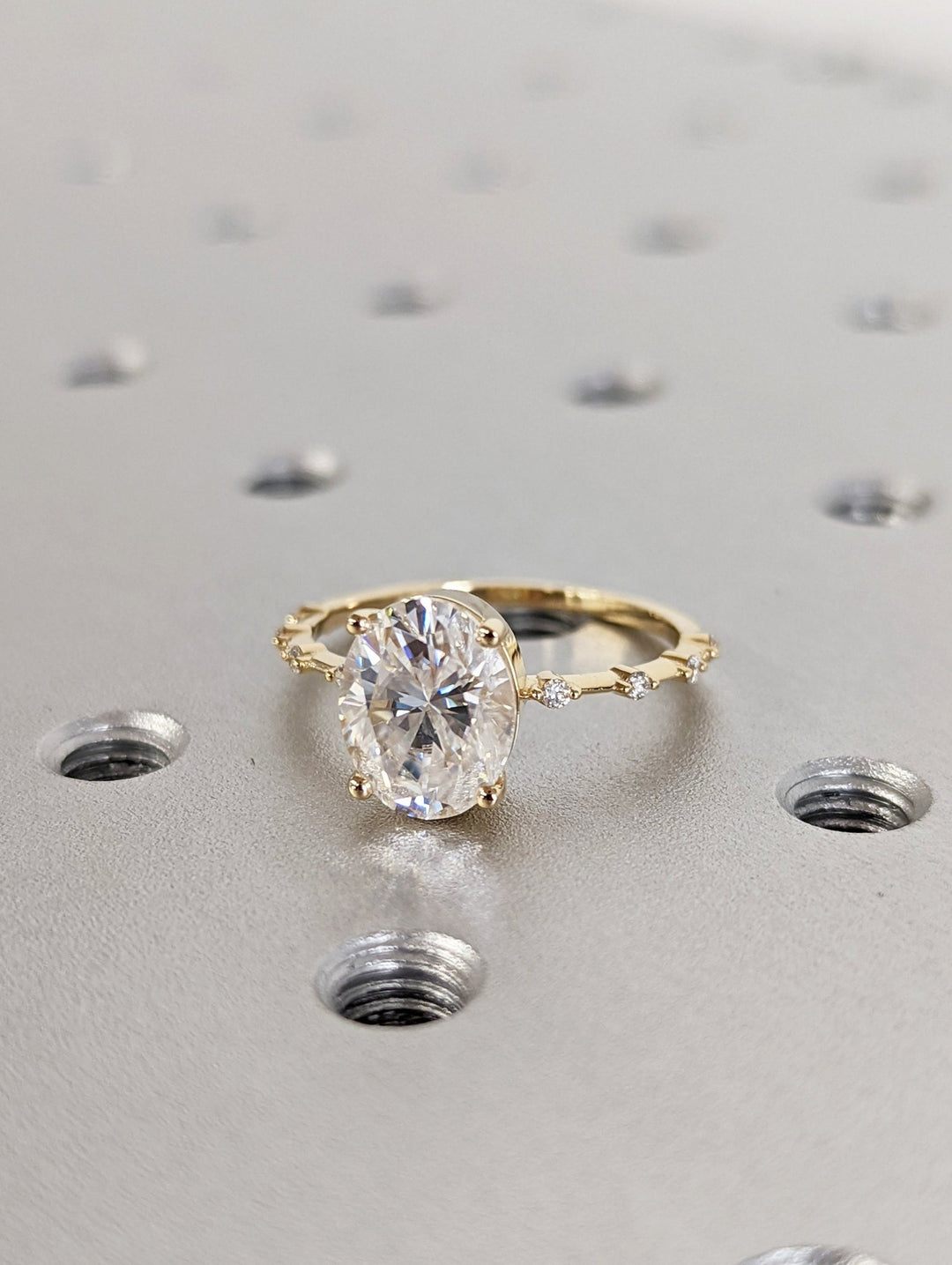 Oval cut engagement ring shown with authenticity certificate