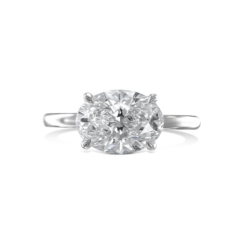 Oval solitaire engagement ring shown on hand for true-to-life sizing