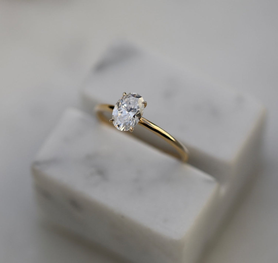 Oval solitaire engagement ring close-up showing E/VVS2 diamond clarity