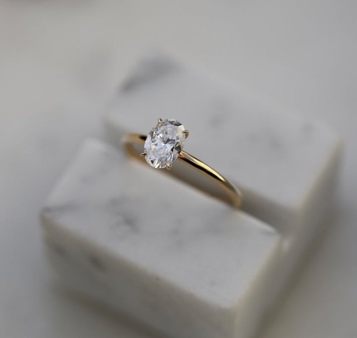Oval solitaire engagement ring close-up showing E/VVS2 diamond clarity