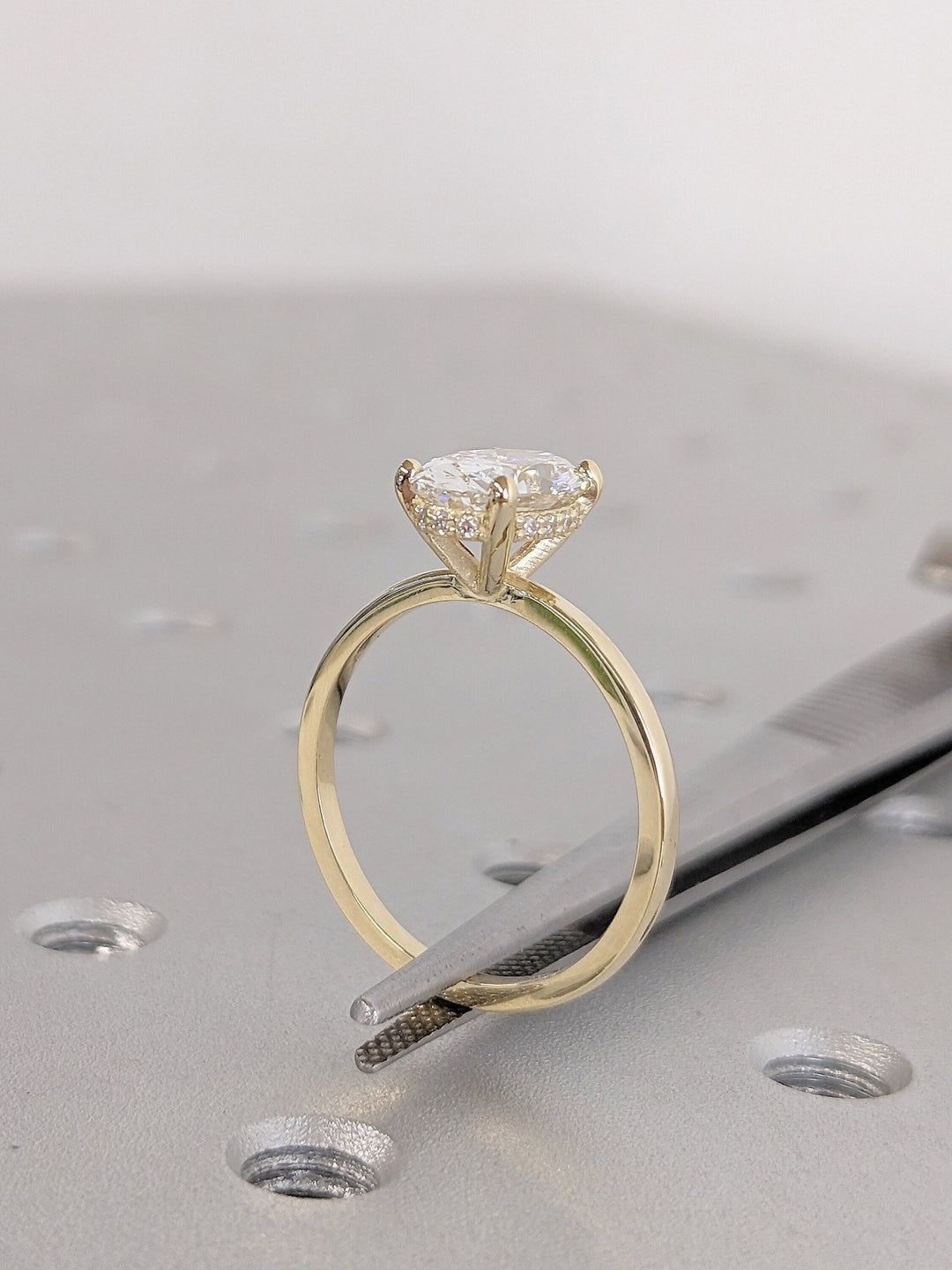 Oval cut hidden halo engagement ring shown in real-life wear