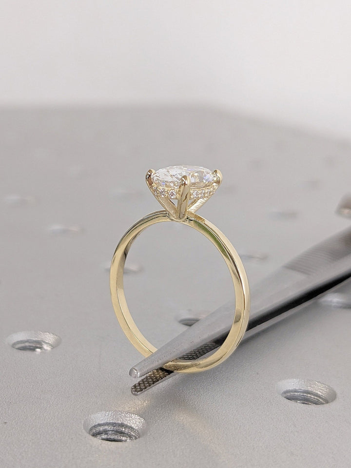 Oval cut hidden halo engagement ring shown in real-life wear