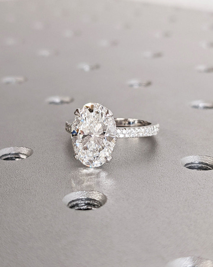 IGI certified oval cut diamond in hidden halo engagement ring setting