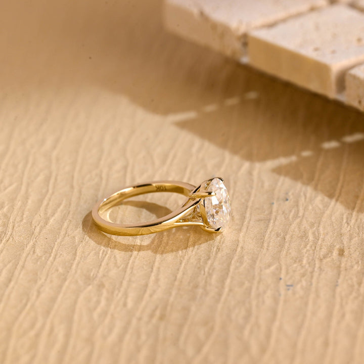 Close-up of oval cut center diamond in split shank engagement ring