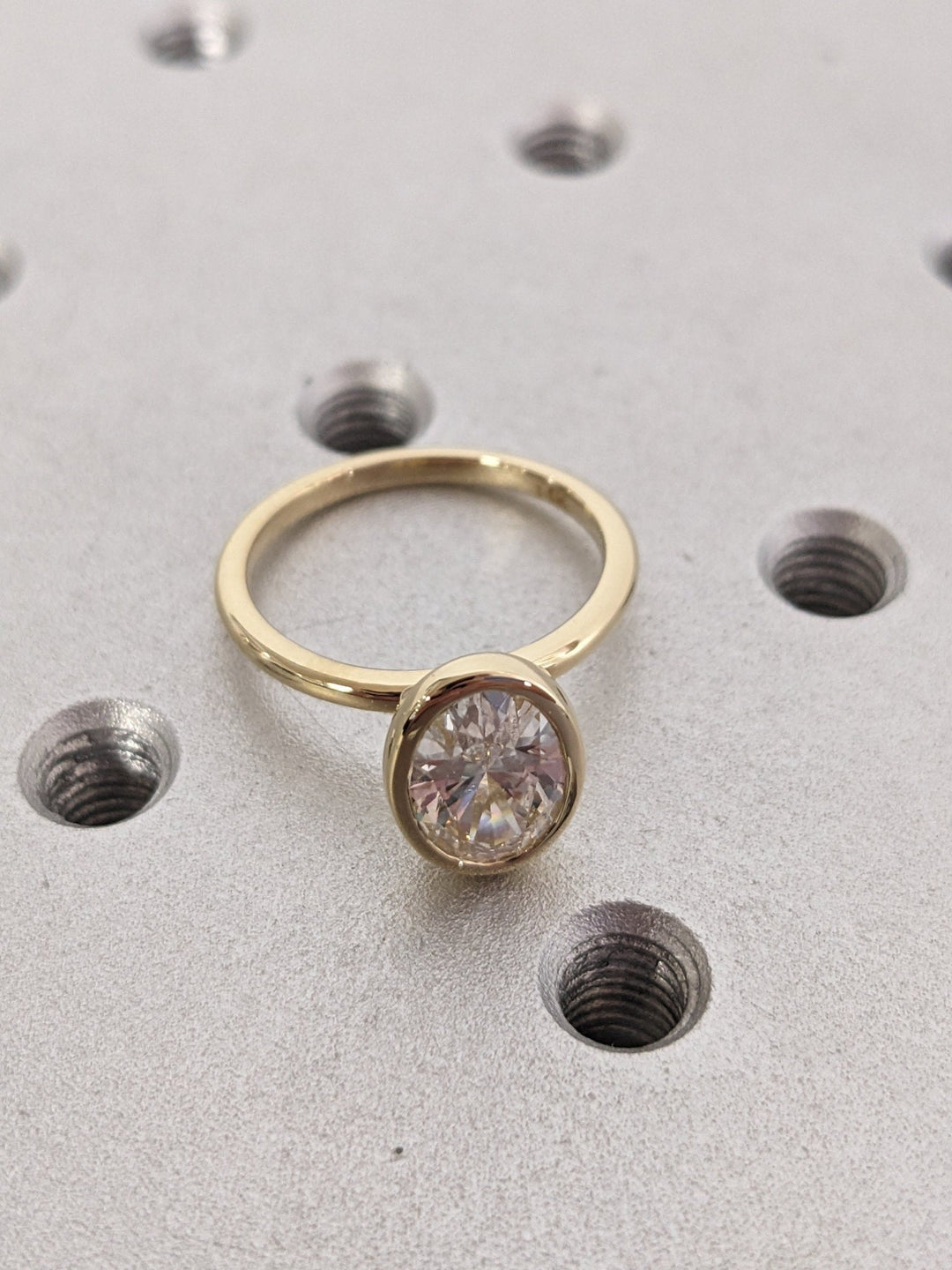 Oval bezel engagement ring with brilliant diamond sparkle