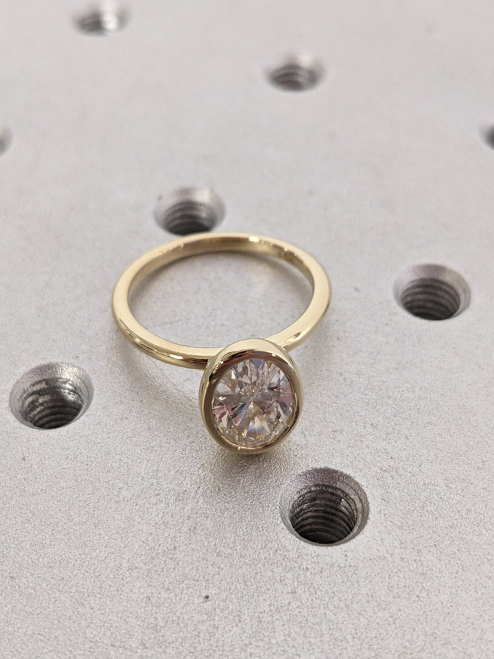 Oval bezel engagement ring with brilliant diamond sparkle