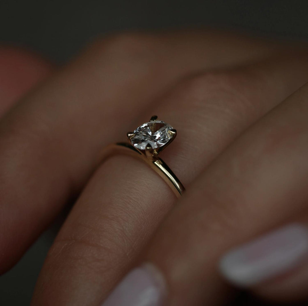 Close-up of oval cut center diamond in solitaire engagement ring