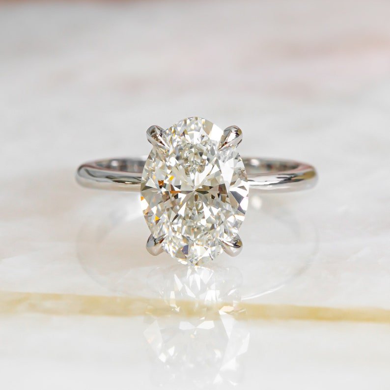 Shop oval hidden halo lab grown diamond engagement ring