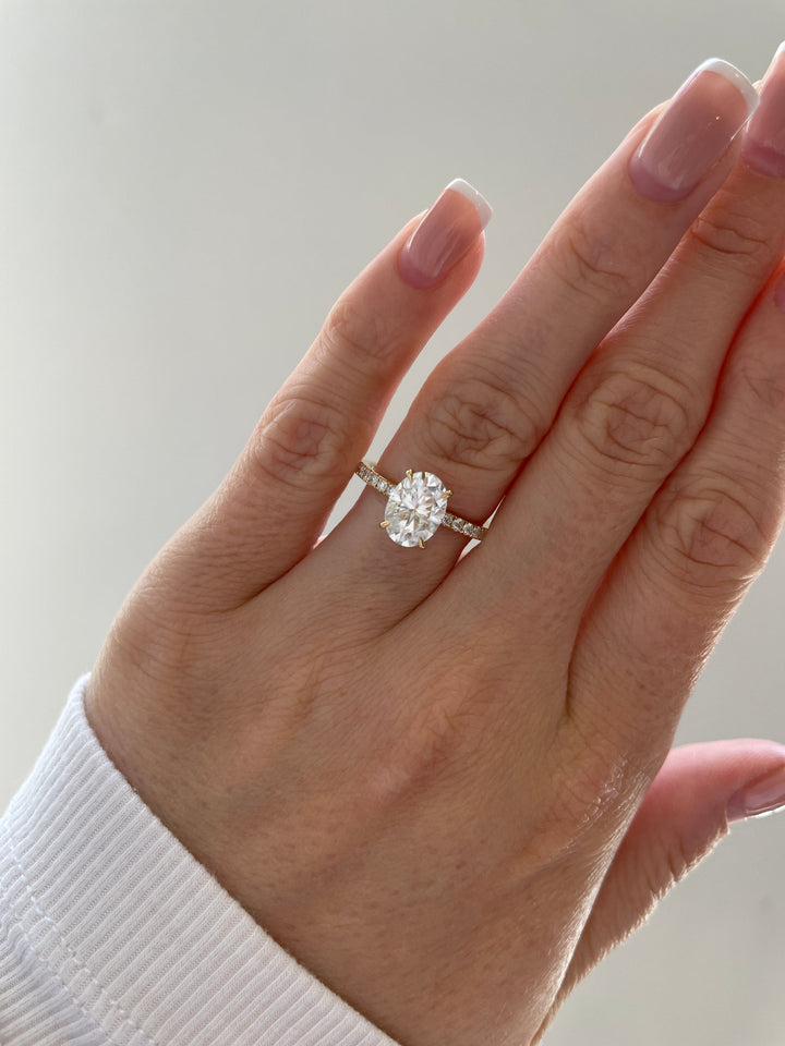 hidden halo pave diamond ring, pave engagement ring, lab grown diamond engagement ring, oval diamond engagement ring, ethical diamond engagement ring, sustainable engagement ring, luxury engagement ring, modern engagement ring design, oval cut diamond ring, bridal