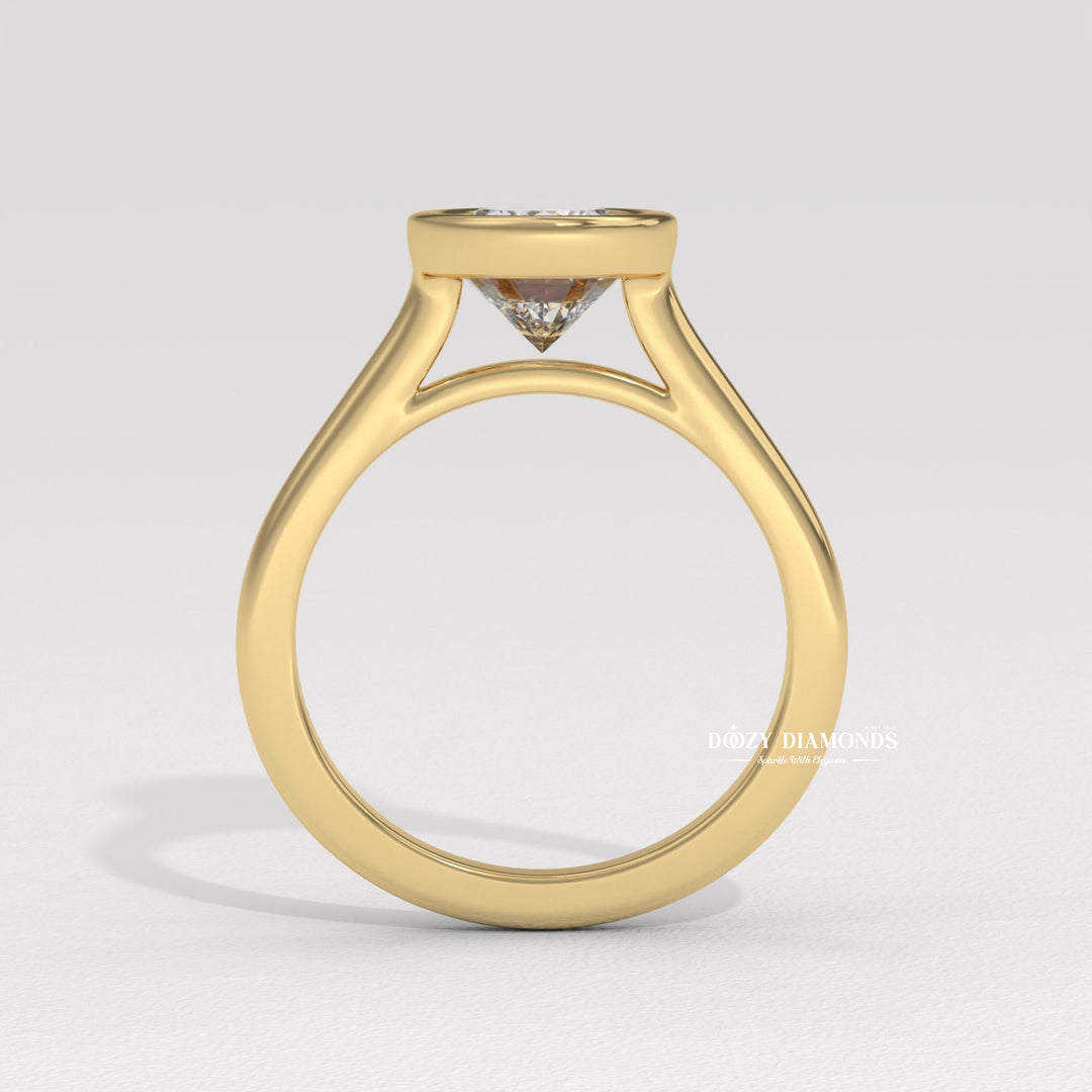 Close-up of oval cut center diamond in bezel engagement ring