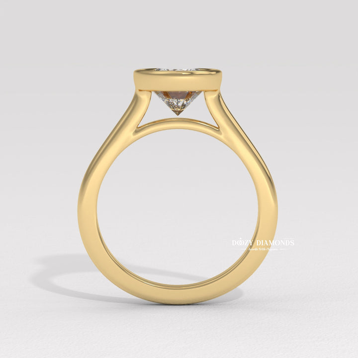 Close-up of oval cut center diamond in bezel engagement ring