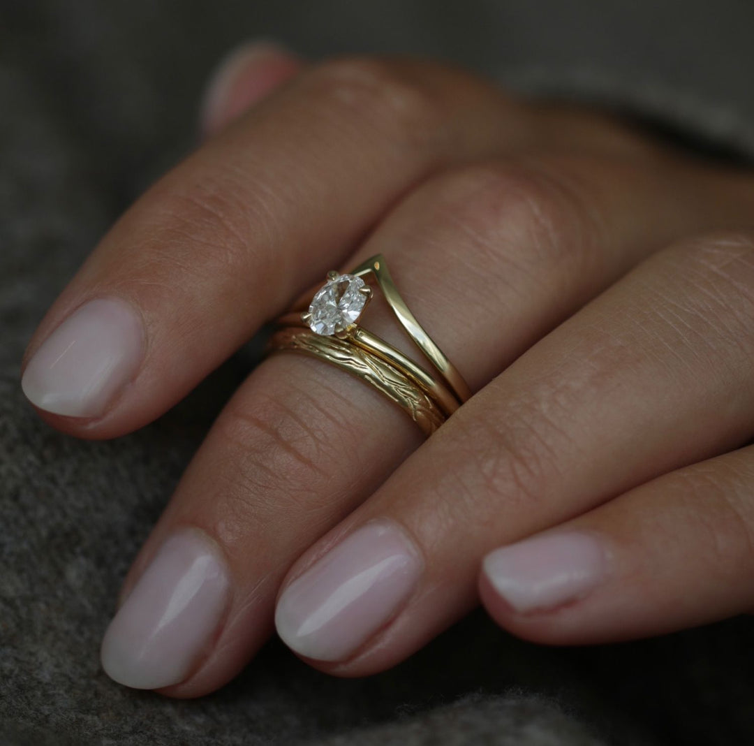 Side angle of oval solitaire diamond engagement ring