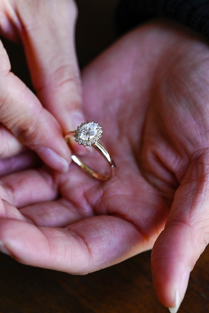Detailed close-up of oval solitaire diamond engagement ring