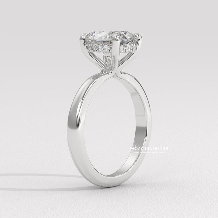 Lifestyle shot of oval solitaire diamond ring on hand