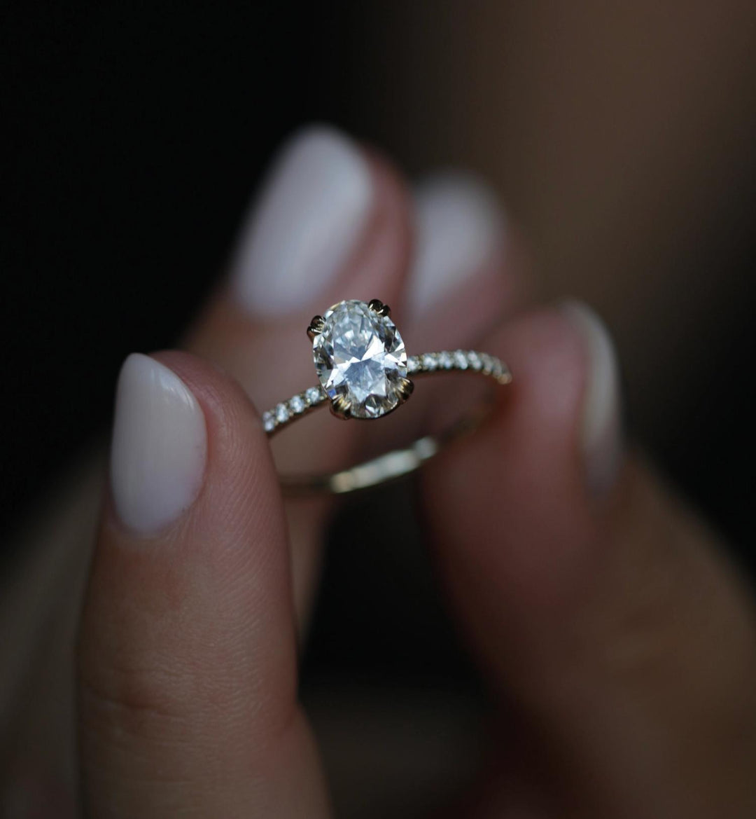 Oval cut solitaire engagement ring shown in real-life wear
