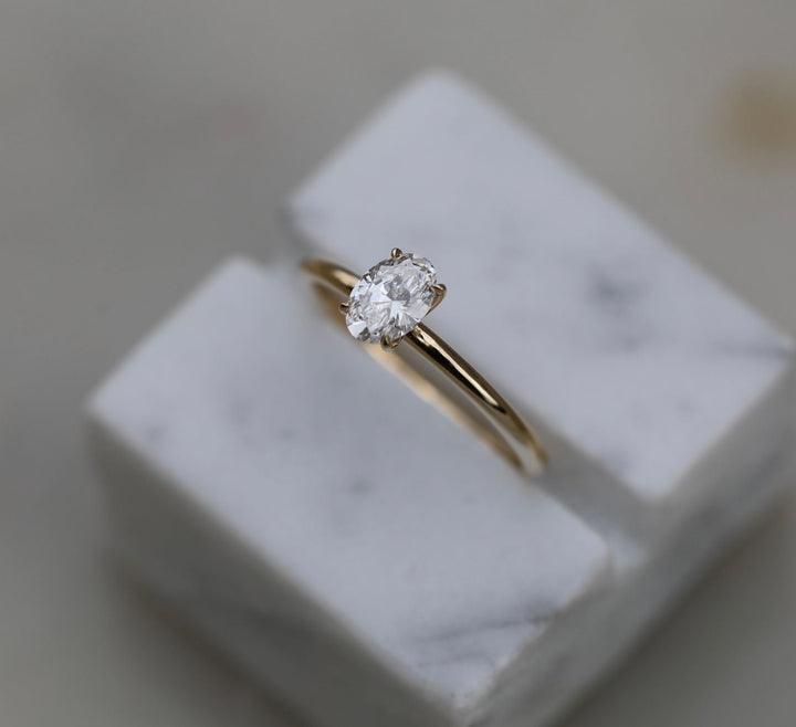 Oval solitaire engagement ring photographed in natural light