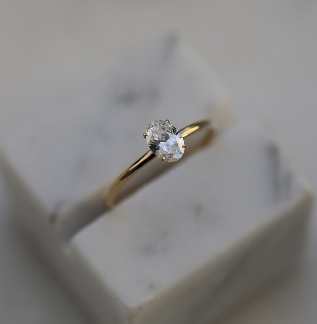 Oval solitaire engagement ring finished in polished solid gold