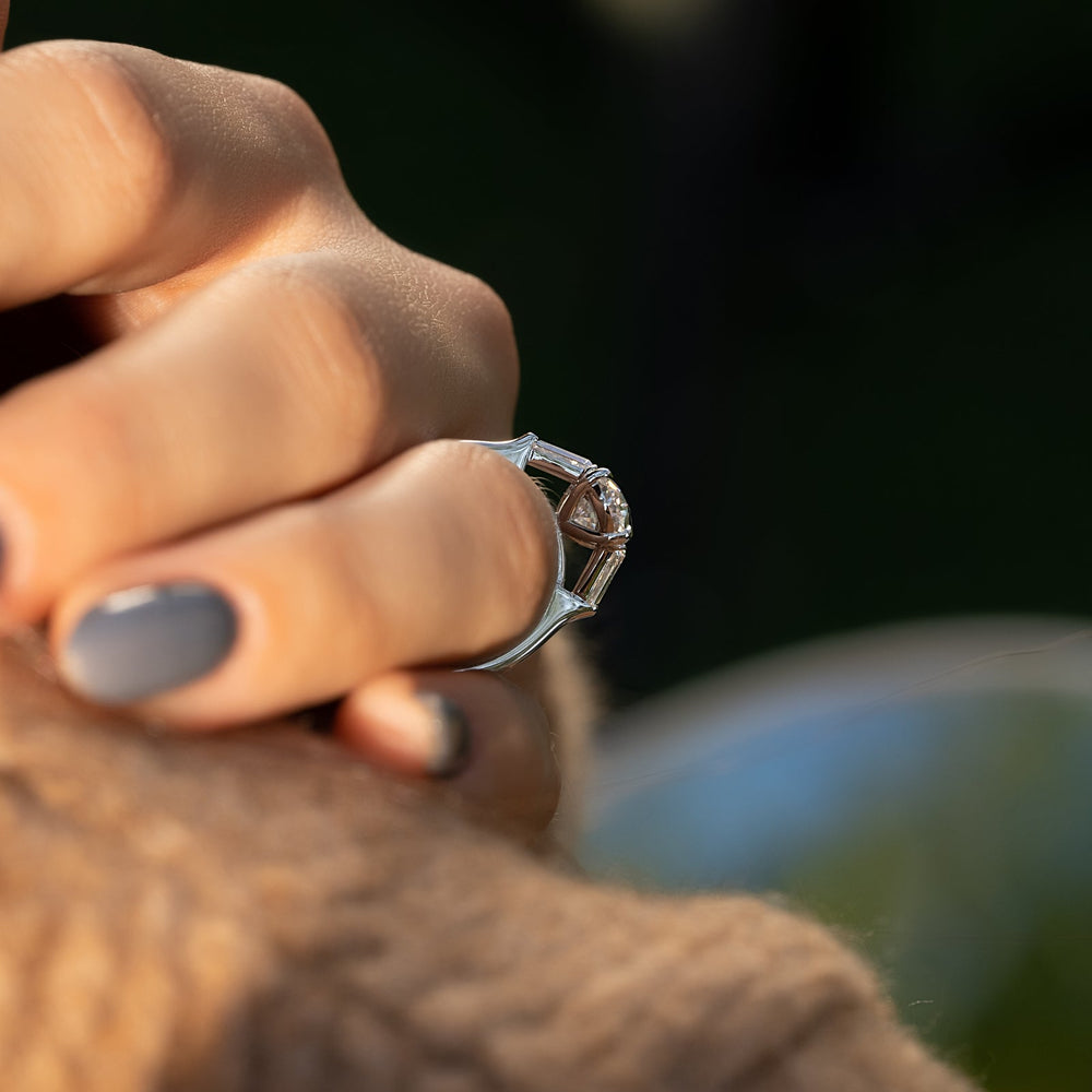 Oval three stone engagement ring finished in polished solid gold
