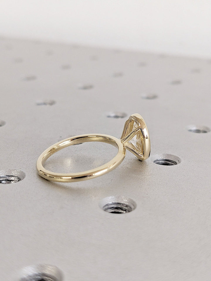 Oval bezel engagement ring close-up highlighting diamond sparkle