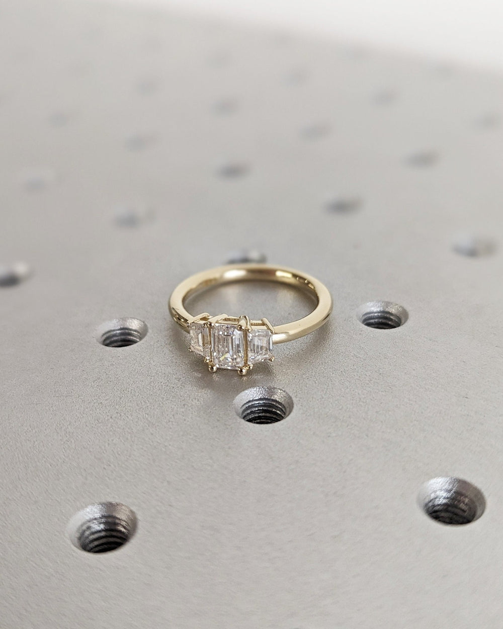 Close-up of emerald cut center diamond in solitaire engagement ring