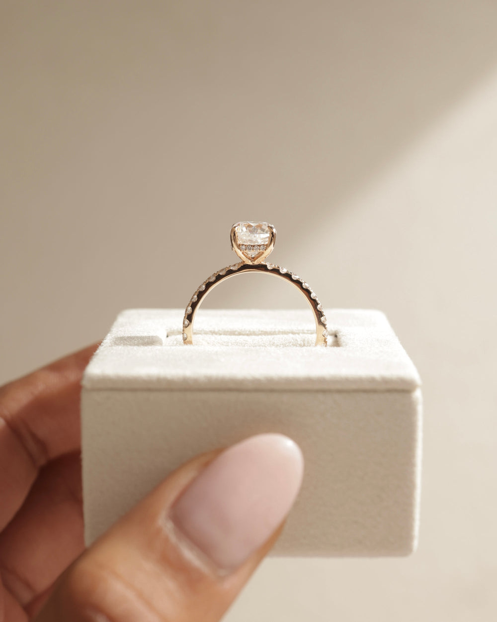 Cushion hidden halo engagement ring close-up highlighting diamond sparkle