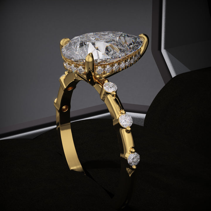 Pear hidden halo engagement ring close-up showing E/VS1 diamond clarity
