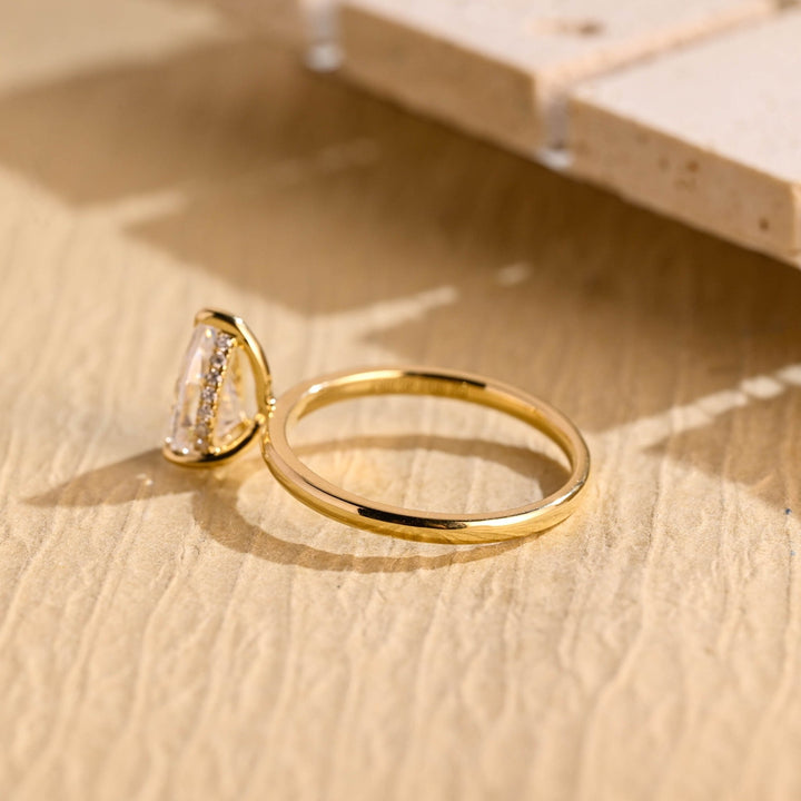 Pear hidden halo engagement ring photographed in natural light