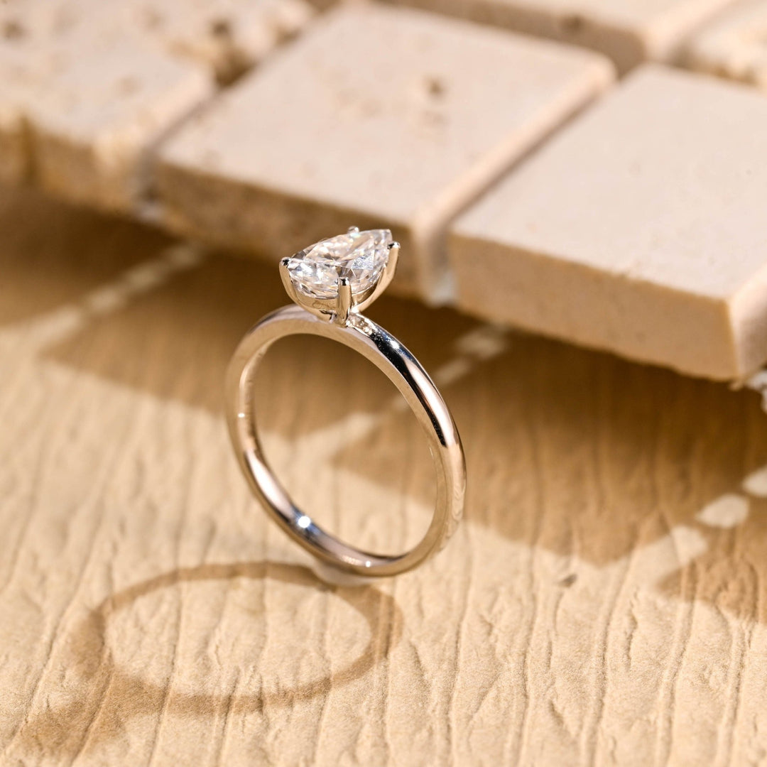 Pear solitaire engagement ring finished in polished solid gold