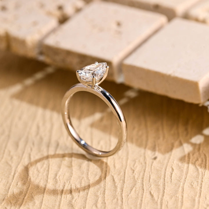 Pear solitaire engagement ring finished in polished solid gold
