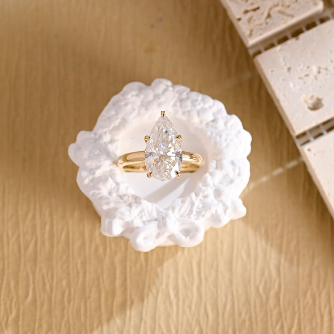Side angle of pear hidden halo diamond engagement ring