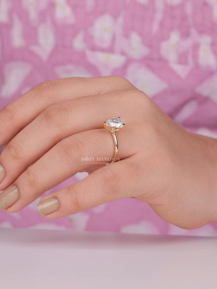 Pear cut solitaire engagement ring shown in real-life wear